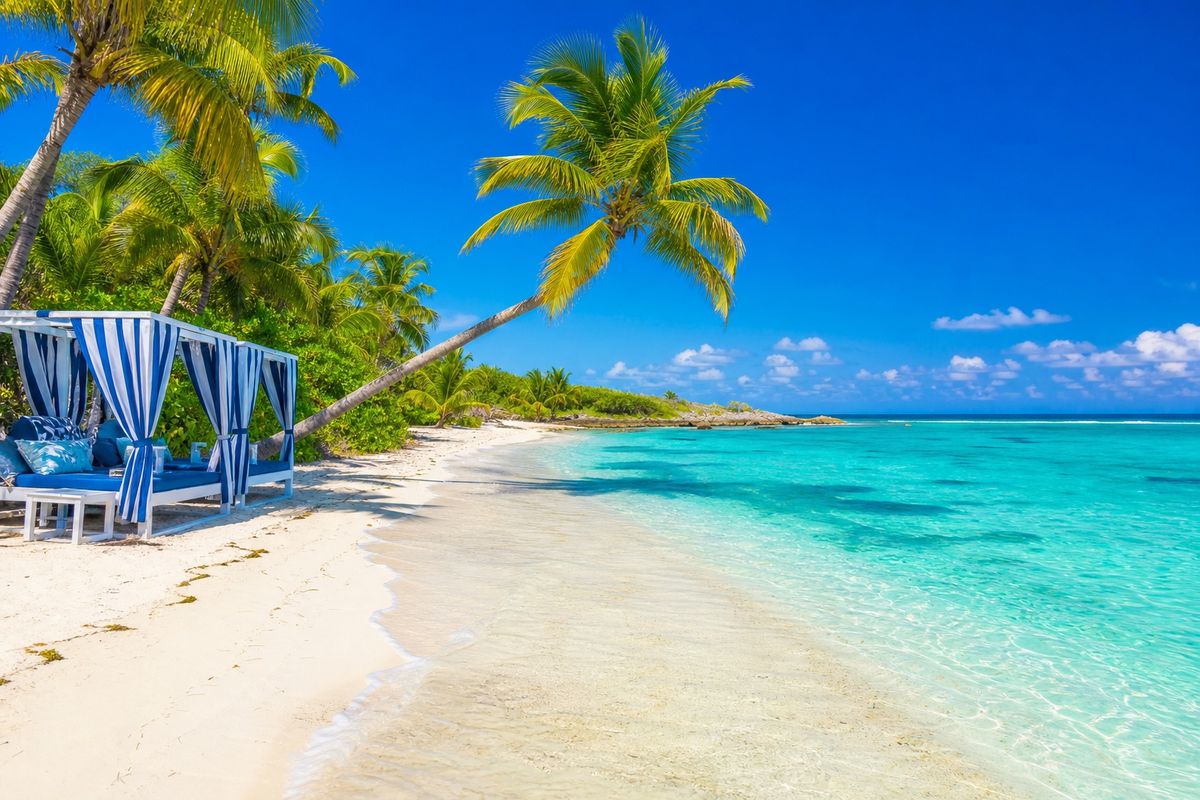 White-sand Bahamas beach with palm trees and a cabana